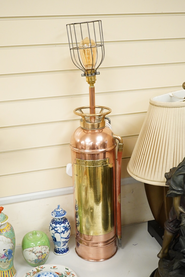 A copper fire extinguisher mounted as a table lamp, overall 93cm high